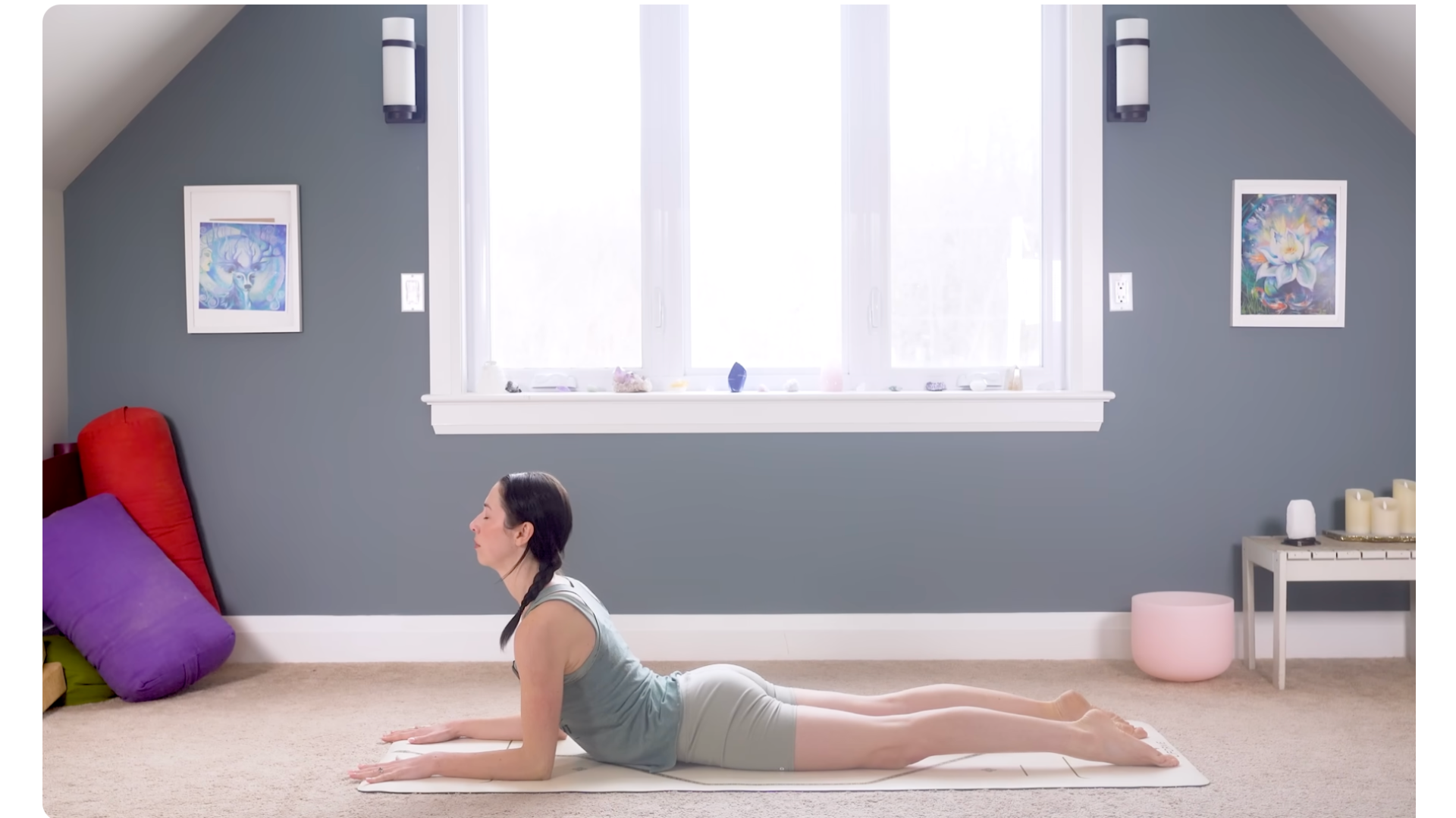 Woman on a yoga mat lifting her chest in Sphinx Pose during a yoga for flexibility practice